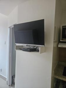 a flat screen tv on a white wall at Studio Reformado coração Leblon in Rio de Janeiro