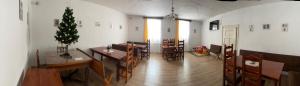 a dining room with a christmas tree and a table and chairs at Zu Hause in Vrbov