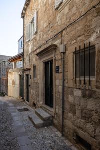 an old brick building with a door on a street at Nono's House II in Dubrovnik