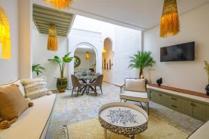 a living room with a couch and a table at Riad Zahra b&b your private house in Marrakech in Marrakech