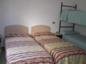 a couple of beds in a room at Centralissimo Mi.Ma in Milano Marittima