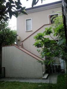 a white house with a staircase in front of it at Centralissimo Mi.Ma in Milano Marittima