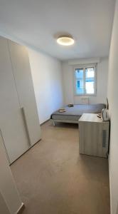 a bedroom with a bed and a window at *Veranda's rooms* - Free parking in central Lugano in Lugano