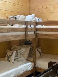 a group of bunk beds in a room at The Grand Tennessean Cabin- Four Bedroom Luxury Cabin in the Mountains in Pigeon Forge