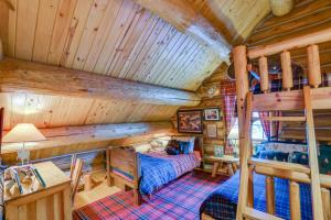 a bedroom with a bunk bed in a cabin at Handcrafted Log Home on River Near Crystal Mtn in Thompsonville
