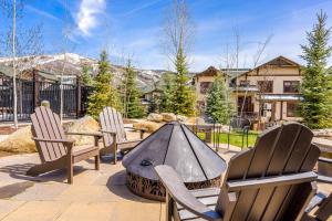 a patio with three chairs and a fire pit at EagleRidge Lodge and Townhomes in Steamboat Springs