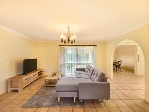 a living room with a couch and a tv at Steps from Mall Super Convenient 3BR Cozy House in Brisbane