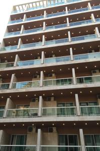 an apartment building with balconies and windows at Dreams Suites in Beirut