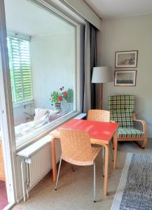 a room with a red table and chairs and a window at Peaceful apartment on Sofiankatu Turku Center Free parking in Turku