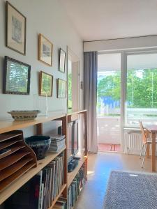 a living room with a book shelf filled with books at Peaceful apartment on Sofiankatu Turku Center Free parking in Turku
