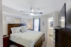 a bedroom with a bed and a flat screen tv at Lake Ozark Vista in Lake Ozark