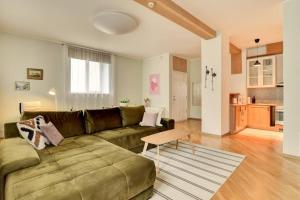 a living room with a couch and a table at Serene 1BR with Sauna & Private Entrance in Tallinn