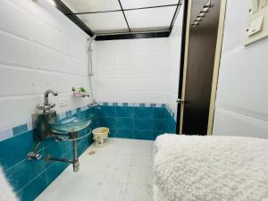 a bathroom with a sink and blue tiles at WisTree Luxury Service Apartment-Bkc in Mumbai