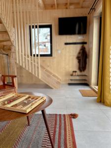 a living room with a table and a staircase at Cicho Tu in Bukowina Tatrzańska