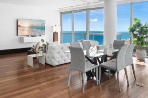 a living room with a white couch and a table and chairs at THE SETAI 5 STARS HOTEL-RESIDENCE MIAMI BEACH OCEANVIEW 2 Bedroom UNIQUE in Miami Beach