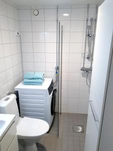 a bathroom with a toilet and a shower at Peaceful apartment on Sofiankatu Turku Center Free parking in Turku