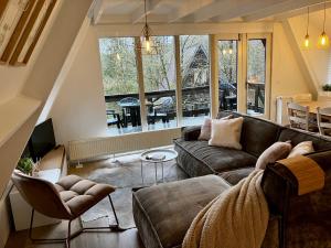 a living room with a couch and a table at Chalet 190 La Belle Durbuy in Durbuy +102 photos