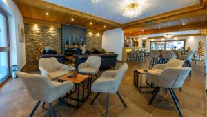 a lobby with chairs and a bar in a restaurant at Hotel Haus Lungau in Mauterndorf