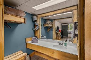 a bathroom with a sink and a mirror at Stonegate Lodge Pool Fire Pits King BedFast WiFi 50in TV Room #209 in Eureka Springs +10 photos
