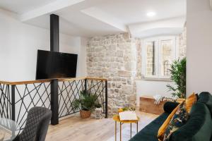 a living room with a couch and a tv at Nono's House II in Dubrovnik