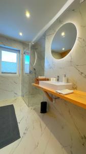 a white bathroom with a sink and a mirror at Apartament Podwika in Zakopane