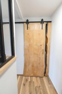 a sliding barn door in a room with wooden floors at LE FACTORY aux pieds de la gare SNCF Laval in Laval
