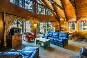 a living room with a blue couch and a tv at Donner Lakefront Retreat in Truckee