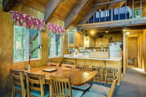 a kitchen and dining room with a wooden table and chairs at Donner Lakefront Retreat in Truckee