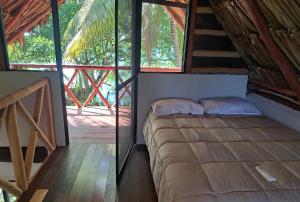 a bedroom in a tree house with a bed at Xanthus Hotel in Huay Pix