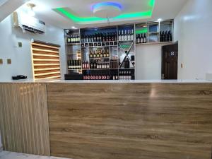 a bar with a wooden counter with wine bottles at B&Y ROYAL BAR & LOUNGE ADIGBE ROAD ABEOKUTA NEAR ADIGBE POLICE STATION AFTER PANSEKE in Abeokuta