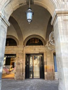 an entrance to a building with a chandelier at Hostal Porxos Garden in Barcelona