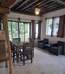 a living room with a wooden table and chairs at Xanthus Hotel in Huay Pix