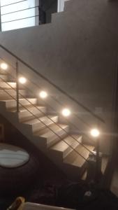 a set of stairs with lights in a room at Casa estrada da torre in Ilhabela