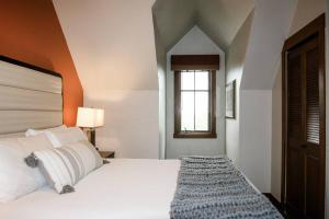 a bedroom with a large white bed and a window at Hyatt Main Street Station 3BD B - Steps to Peak 9 in Breckenridge +22 photos