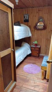 a bedroom with two bunk beds and a table at Cabañas costa maule in Constitución