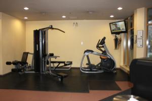 a gym with treadmills and exercise bikes in a room at Cascade Lodge suite GENIUS SPECIAL WIFI cable HDTV across from Whistler Village air conditioning heating pay underground parking pool 2 hot tubs sauna gym in Whistler