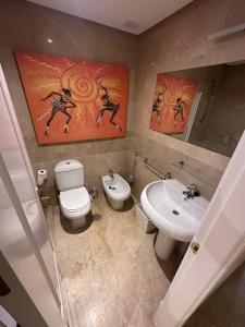 a bathroom with a toilet and a sink at Marina de la duquesa 602 in Castillo de Sabinillas