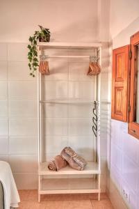 a walk in closet with a glass shelf at La Bombonera in Catadau