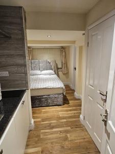 a bedroom with a bed in the middle of a room at Entire en-suite flat in Windsor home with free parking in Windsor