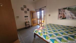 a bedroom with a bed in the corner of a room at 2nd Floor Bedroom Homestay in Jalandhar