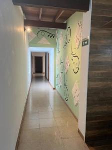 a hallway with a wall with writing on it at Excellent House (Laureles) Jacuzzi and 6 Rooms in Medellín