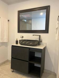 a bathroom with a sink and a mirror at Excellent House (Laureles) Jacuzzi and 6 Rooms in Medellín
