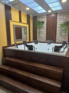 a large bathroom with a tub with chairs in it at Excellent House (Laureles) Jacuzzi and 6 Rooms in Medellín