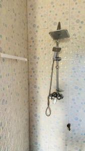a shower with a camera on the wall at Independent apartment in a villa in Ouagadougou