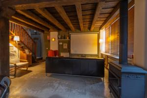 a large room with a projection screen and a board at Alojamiento rural, Adrados Mar de Pinos in Adrados