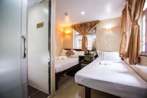 Katil atau katil-katil dalam bilik di Joyous Guest House
