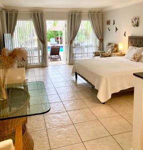 a bedroom with a bed and a glass table at Beach Aqualina Apartments in Fort Lauderdale