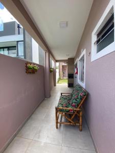 a hallway with a couch sitting on the side of a building at Residencial Mariano 5 in Florianópolis
