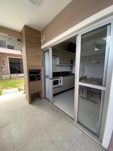 a kitchen with stainless steel appliances and sliding glass doors at Residencial Mariano 5 in Florianópolis