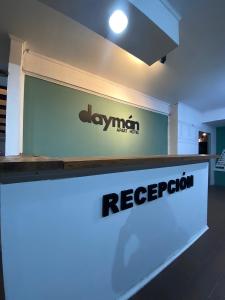 a sign for a reception desk in a building at Daymán Apart Hotel in Termas del Daymán